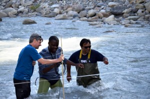 Associate Professor of Hydraulic Engineering, Dr. Micha Werner (left); Nigerian UNESCO-IHE student,  Kenechukwu “Kaycee” Okoli (middle); and another student, Faris Qazi, estimating the water flow rate in a river basin, during a field work for the Hydraulic Engineering and River Basin Development specialisation programme, at Basin of La Bléone River near Digne les Bains, France 