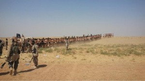 Photos posted online appeared to show dozens of men being marched through the desert