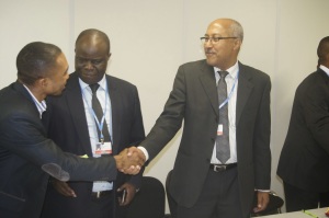 Chair of the African Group of Negotiators on Climate Change, Nagmeldin G. Elhassan (right), in a handshake with Samual Samson Ogallah of the Pan-African Climate Justice Alliance (PACJA)