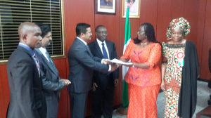 Minister of Lands, Housing & Urban Development, Akon Eyakenyi (second right), shaking hands with Anand Ramani (third left) of the Dubai-based Signature Value Homes. Minister of State, Federal Capital Territory (FCT) Development, Jumoke Akinjide (right); Permanent Secretary in the Lands, Housing & Urban Development Ministry, George Ossi, and other guests look on.