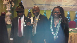 Dr Femi Olomola (middle)   after being decorated by the immediate past president, Chief Steve Onu (left). Mrs Kunbi Olomola (right) looks on