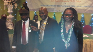 Dr Femi Olomola (middle) after being decorated by the immediate past president, Chief Steve Onu (left). Mrs Kunbi Olomola (right) looks on