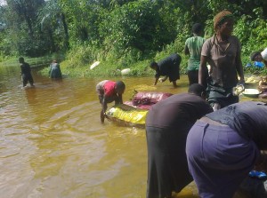 Washing, bathing and fetching drinking water from the same source at the Zor-Sogho Community. Photo credit: Lekara Martin