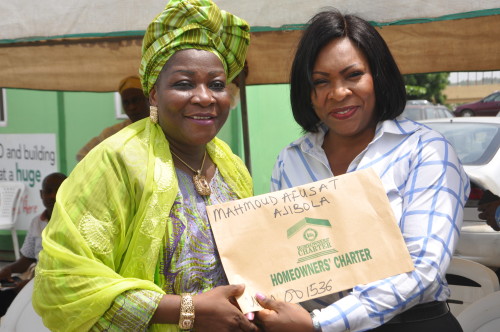 Mrs. Mahmoud Afusat (left), one of the beneficiaries of Certificate of Occupancy and Building Plan Approval of Ogun Homeowners' Charter Scheme, with Mrs. Abimbola Akeredolu, Ogun State Attorney General and Commissioner for Justice, during the presentation of Certificate of Occupancy and Building Plan Approval to the beneficiaries at Arcade Ground, Governor's Office, Oke-Mosan, Abeokuta, recently