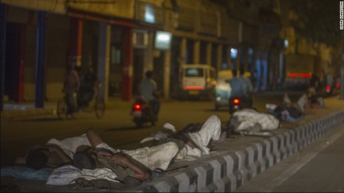 Men sleeping on concrete road dividers during a heat wave in Delhi, India. Photo credit: cnn.com