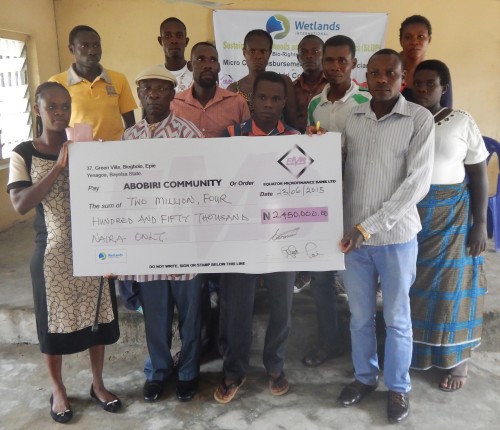 Abobiri beneficiaries with cheque