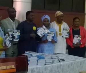 Mr Adesina (with the mike) and other dignitaries during the book presentation in Abuja on Thursday