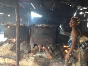 Mother and baby at risk from smoke poisoning as mother processes fresh fish at  SagboKodji Island