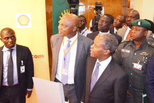 Managing Director of The Shell Petroleum Development Company of Nigeria Ltd and Country Chair, Shell Companies in Nigeria, Mr. Osagie Okunbor (2nd left), conducting Vice President Yemi Osinbajo round the Shell exhibition stand at the 21st Summit of the Nigeria Economic Summit in Abuja… on Tuesday, October 13, 2015