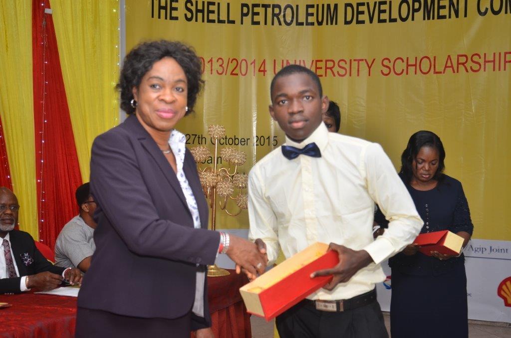 Social Performance and Social Investment Manager, Shell Petroleum Development Company of Nigeria JV, Gloria Udoh presenting a prize to one of the beneficiaries of the 2013/2014 SPDC JV University Scholarship, second year student of Medicine and Surgery, University of Ibadan, Samson Okubanjo at the award ceremony in Port Harcourt recently.