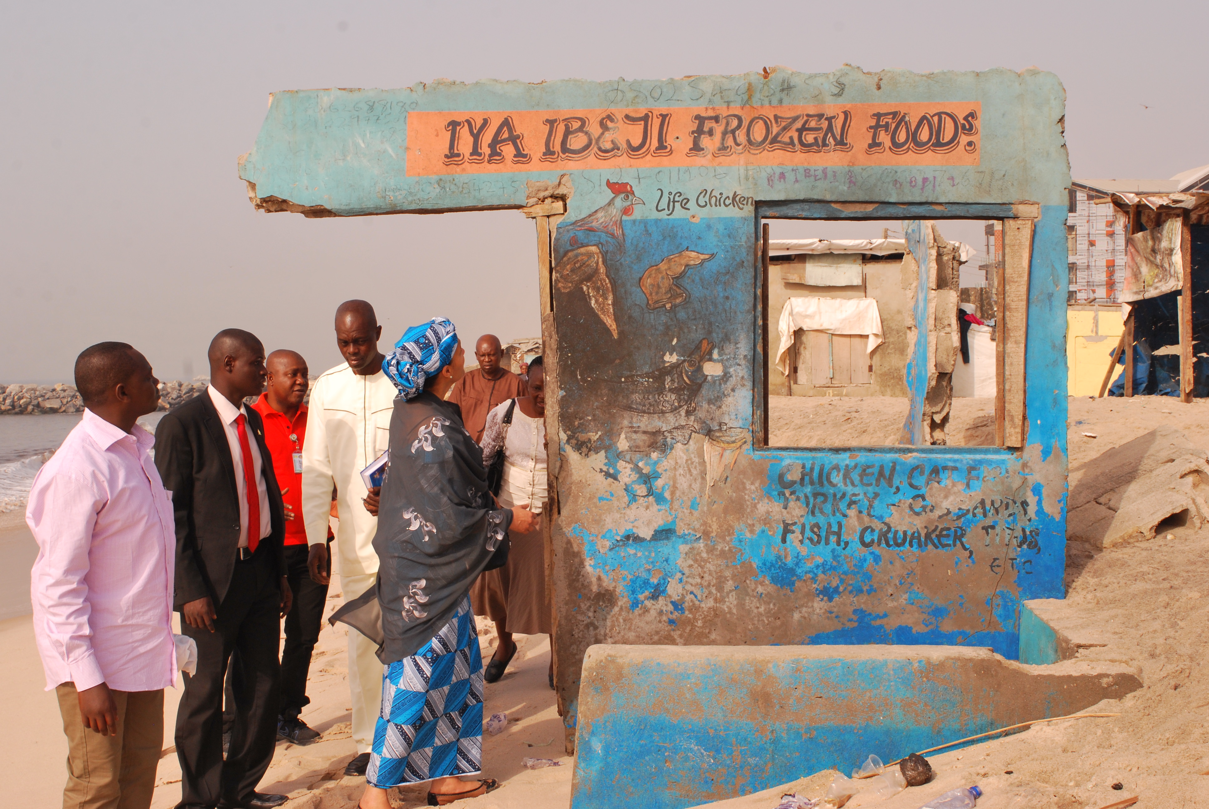 Environment Minister, Amina Mohammed, beside the remains of a structure destroyed by coastal erosion at Alpha Beach, Lagos