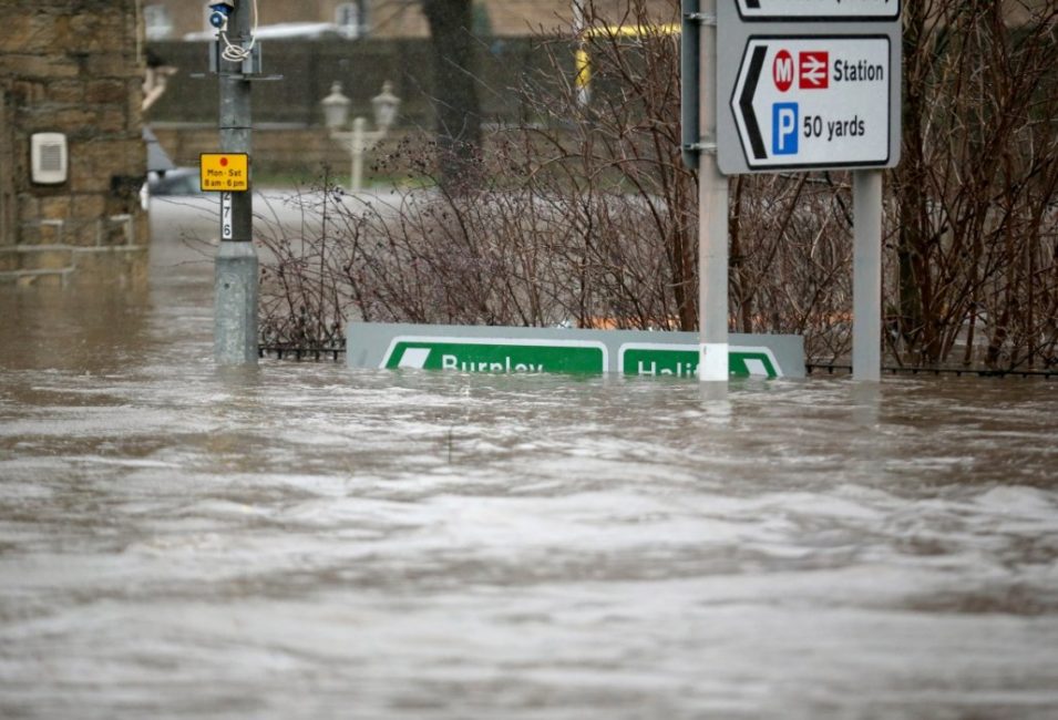 Road signs are half submerged after the River Calder burst its banks in the Calder Valley town of Mytholmroyd on December 26, 2015 in Mytholmroyd, England. Photo credit: www.ibtimes.co.uk