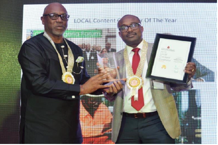 General Manager, Business and Government Relations, Shell Petroleum Development Company, Mr. Simbi Wabote (right), receiving the 2015 PETAN Local Content Operator award from the Executive Secretary, Nigeria Content Development and Monitoring Board, Mr. Denzil Kentebe