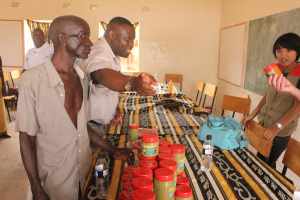 Kafweku (middle) seems to be telling visitors the signficance of Moringa as Chiponda (left) looks on