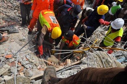 Rescue workers at the building collapse site