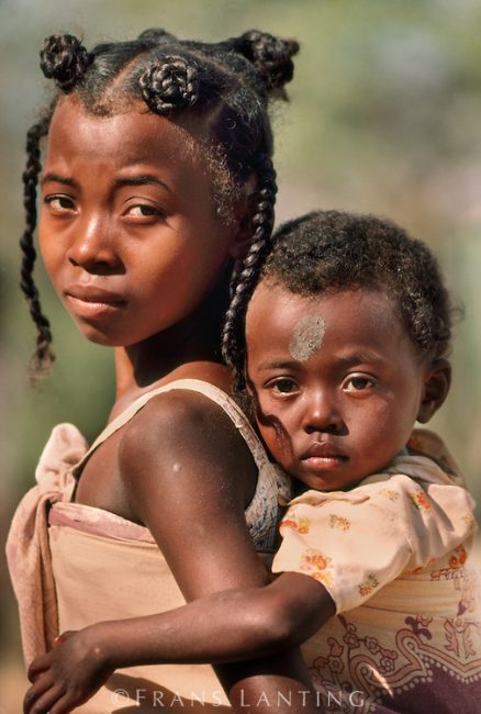 Outcome of child marriage: Mahafaly girl carrying her sibling, Madagascar