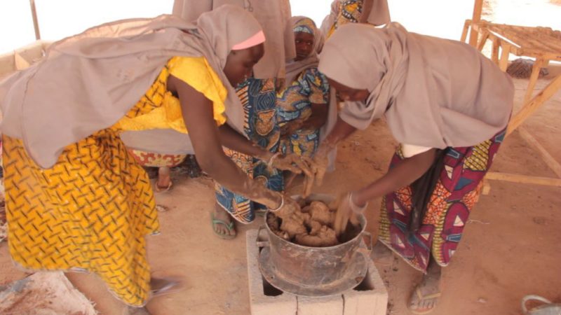 IDP women molding a stove