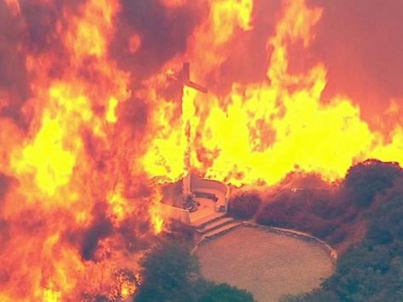 A cross burns in the Blue Cut Fire in the San Bernardino National Forest above Devore on Tuesday, Aug. 16, 2016.