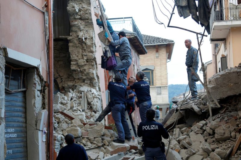 A woman is helped to leave her home by rescuers in Amatrice. Photo credit: Remo Casilli / Reuters