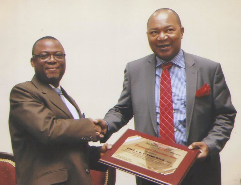 The Vice Chancellor, University of Port Harcourt, Professor Ndowa Lale presents an award to Professor I. K. E. Ekweozor of the River State University of Science and Technology Port Harcourt