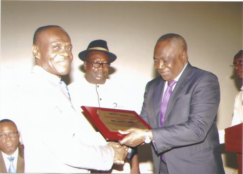Dr. Daru Owei, former DMD of Agip receives an award from the Director-General of NESREA, Dr. Lawrence Anukam while Publisher of the Environment Outreach Magazine admires