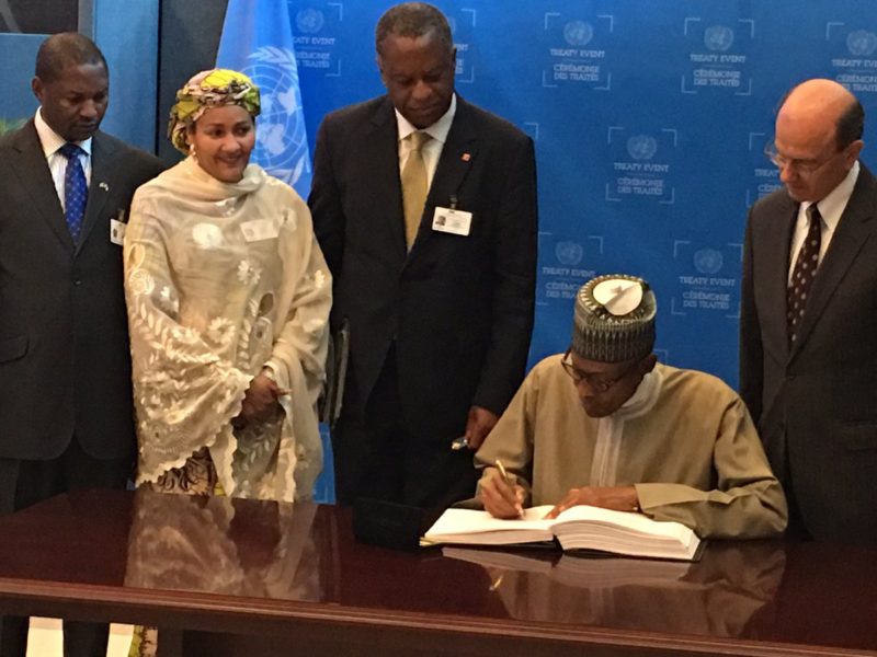 Finally, Mr President puts pen on paper. Environment Minister, Amina Mohammed, and others look on