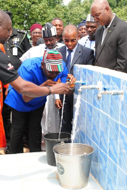 Executive Governor of Benue State, Dr. Samuel Ortom, drinking water as Managing Director, Guinness Nigeria, Peter Ndegwa, looks on during the commissioning ceremony of a water project donated by Guinness Nigeria to the Tyowange community in Benue State