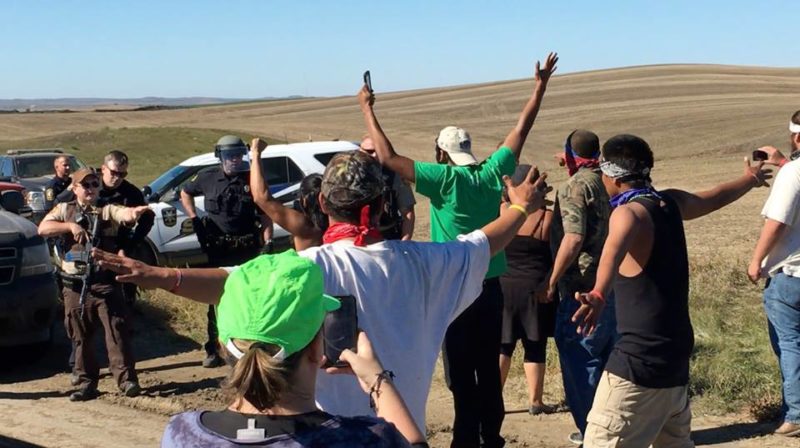 Police confront a group people protesting against the Dakota Access Pipeline, which will transport oil across 1,134 miles of Native prairie land, valuable farm land and critical waterways, including the Missouri River