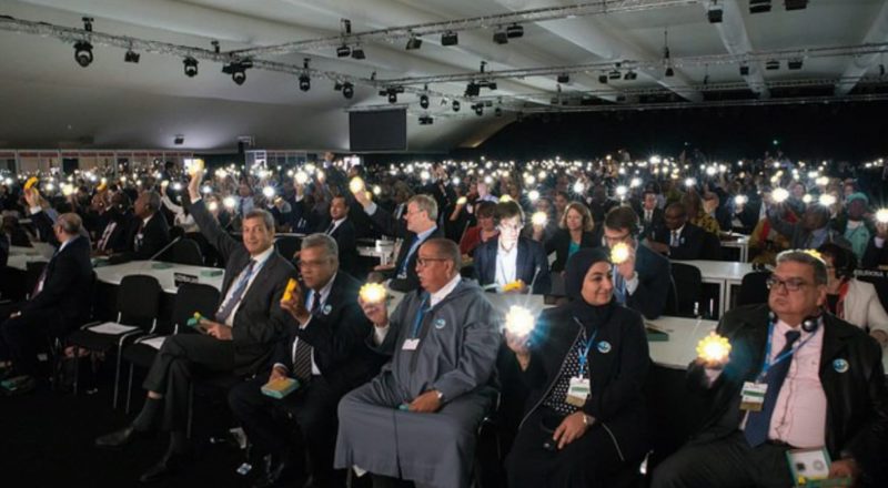 Delegates holding their solar lamps during the opening ceremony. The gesture is a show of solidarity symbolising the transformation to clean technology which is essential to achieve the Paris Agreement goals